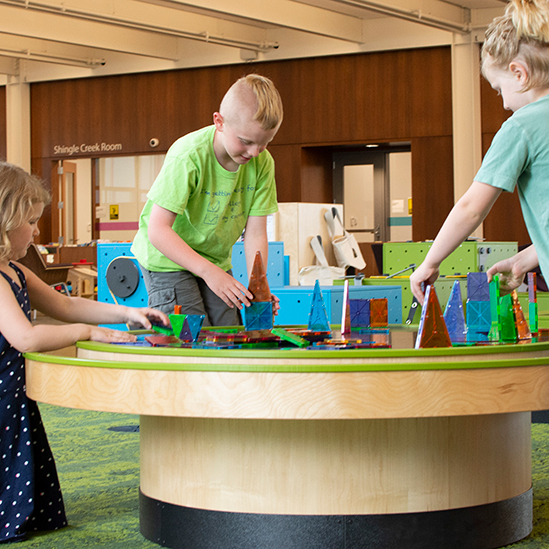 children playing with a multi-activity table